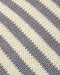 Close-up of a knitted fabric with diagonal stripes in warm off-white and medium gray.