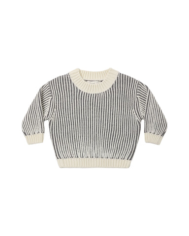 A black and cream long sleeve knit sweater on a white background
