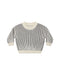 A black and cream long sleeve knit sweater on a white background