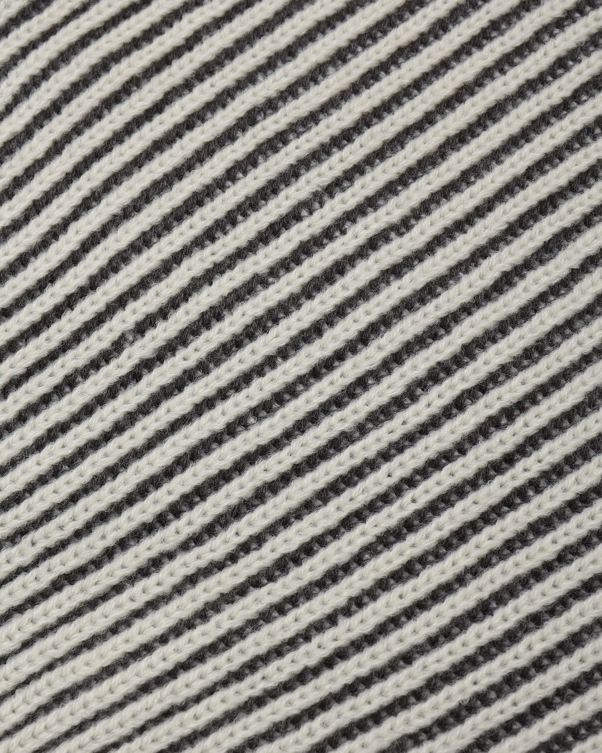 A close up of a  black and cream long sleeve knit 