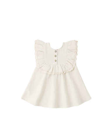 White dress with ruffled details on a white background