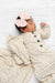 Newborn baby wearing a floral outfit and pink headband on a white background