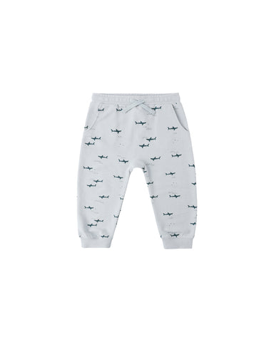 Light blue baby pants with shark pattern on a white background