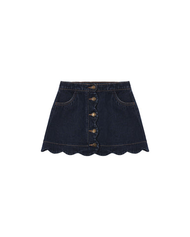 An indigo colored denim skirt with scalloped edge and brass buttons down the front.