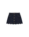 An indigo colored denim skirt with scalloped edge and brass buttons down the front.