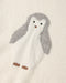 A close-up of a soft knit fabric featuring a penguin motif in white and gray with small brown accents.