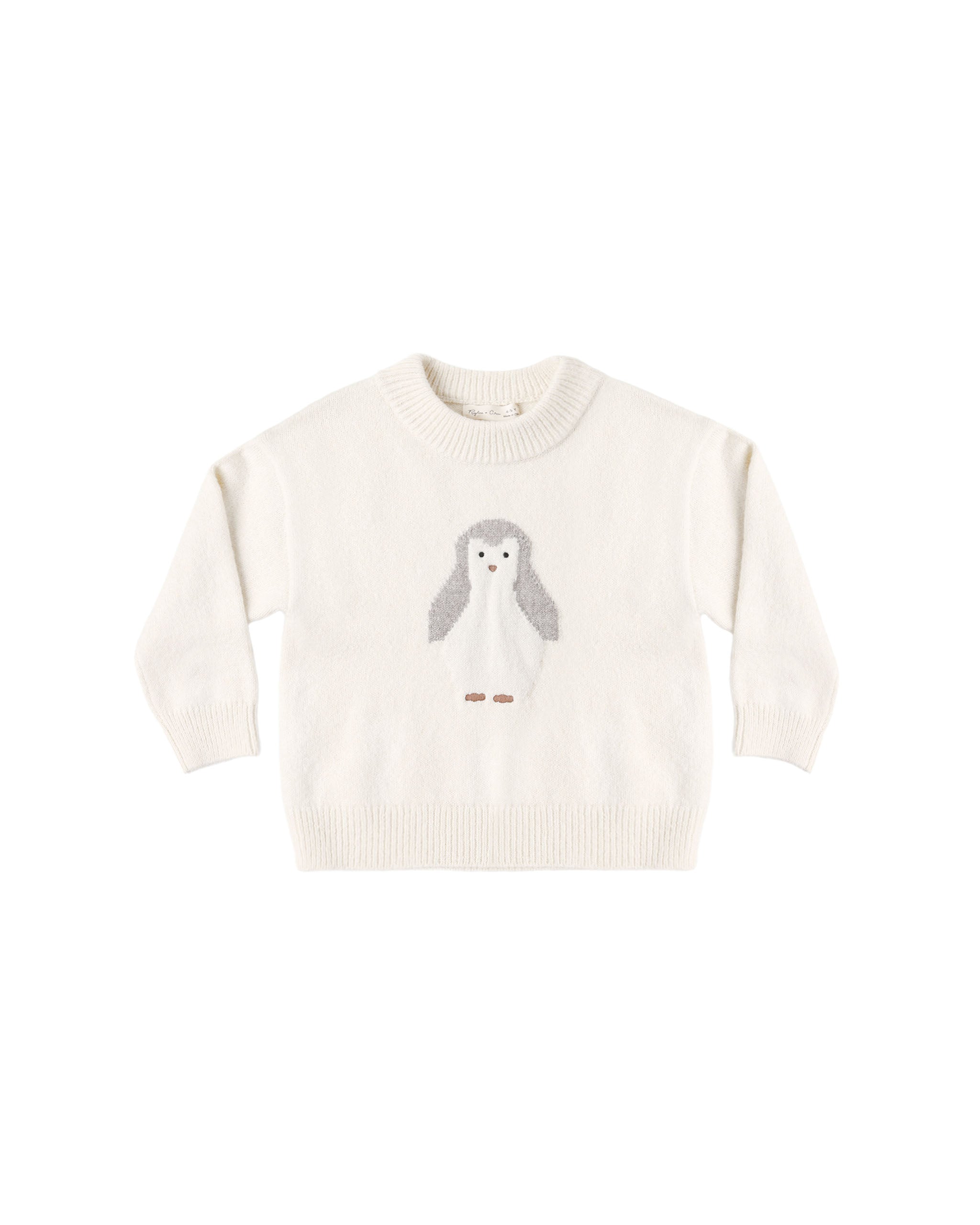 An off-white knit crewneck sweater featuring a central penguin motif with gray wings and small brown feet, displayed flat against a solid white background.
