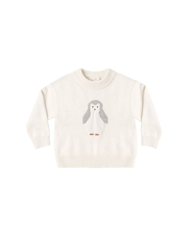 An off-white knit crewneck sweater featuring a central penguin motif with gray wings and small brown feet, displayed flat against a solid white background.