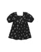 A black toddler girl's dress with a white floral pattern, featuring puff sleeves, a square neckline, and three small decorative buttons at the collar.