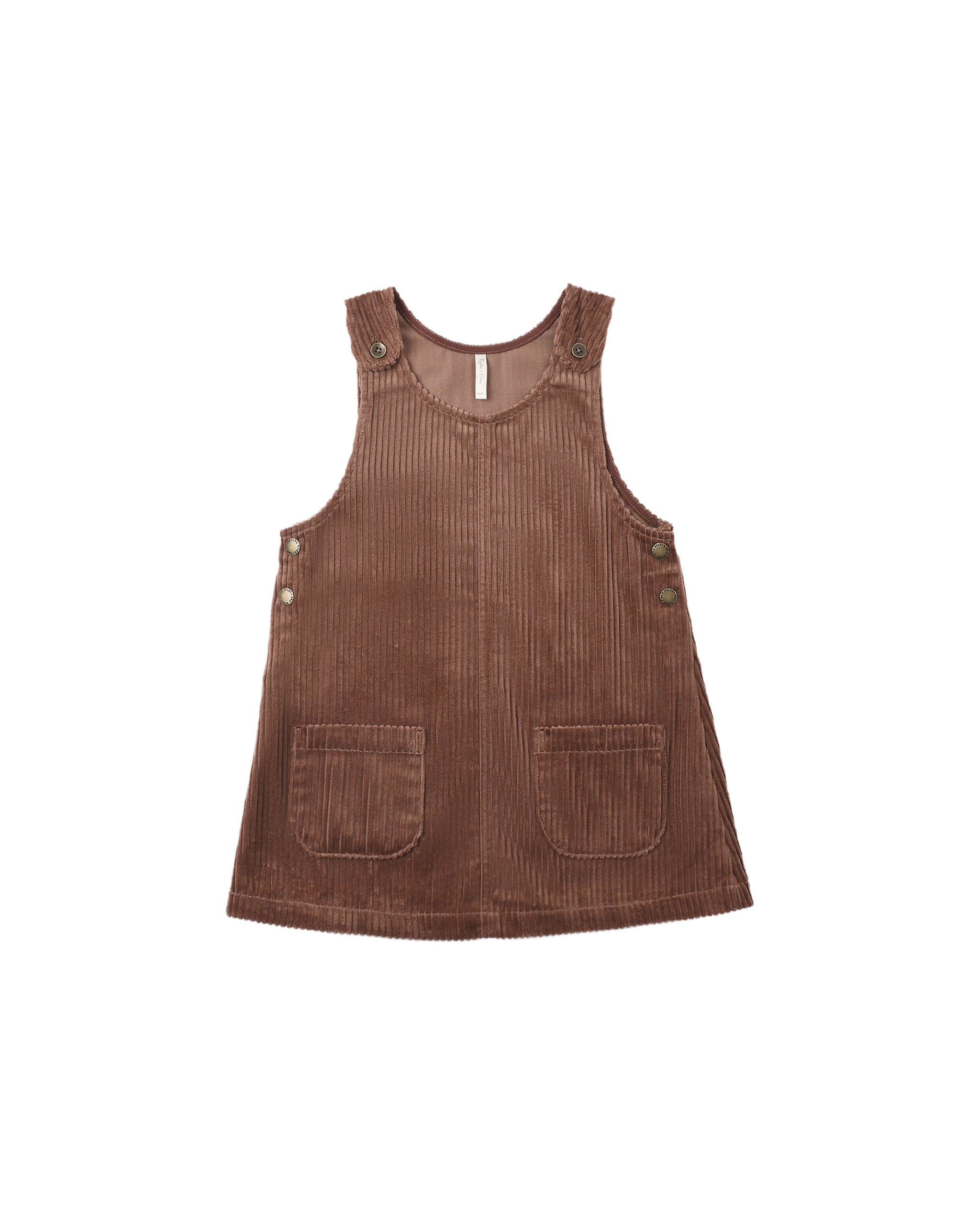 A brown corduroy pinafore dress for toddlers, featuring front patch pockets and decorative buttons on the shoulder straps and armholes, shown against a plain white background.