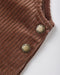 Close-up of a brown corduroy garment corner with two round brass buttons engraved with 'Cru Ayley', on a light gray background.