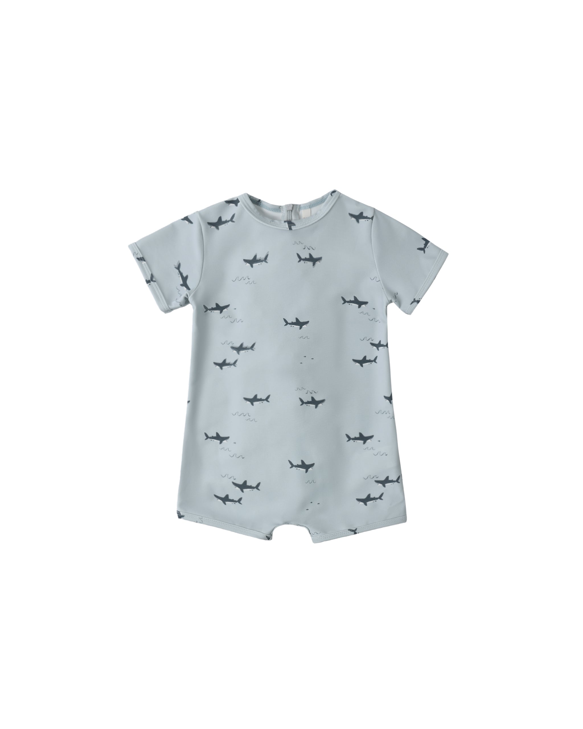 Light blue swim romper with shark pattern on a white background