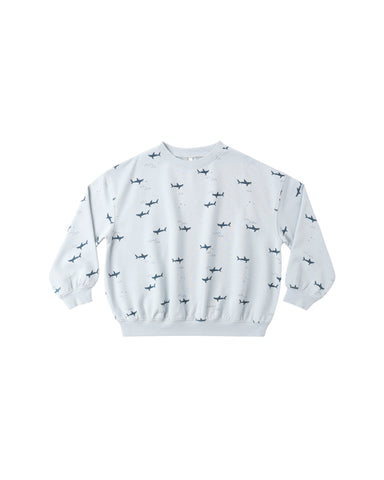 Light blue sweatshirt with shark pattern on a white background