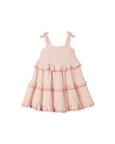 Pink checkered dress with ruffled layers on a white background