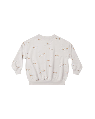 An off-white crewneck sweatshirt featuring a delicate all-over print of small brown foxes and tiny scattered dots, displayed flat against a solid white background.