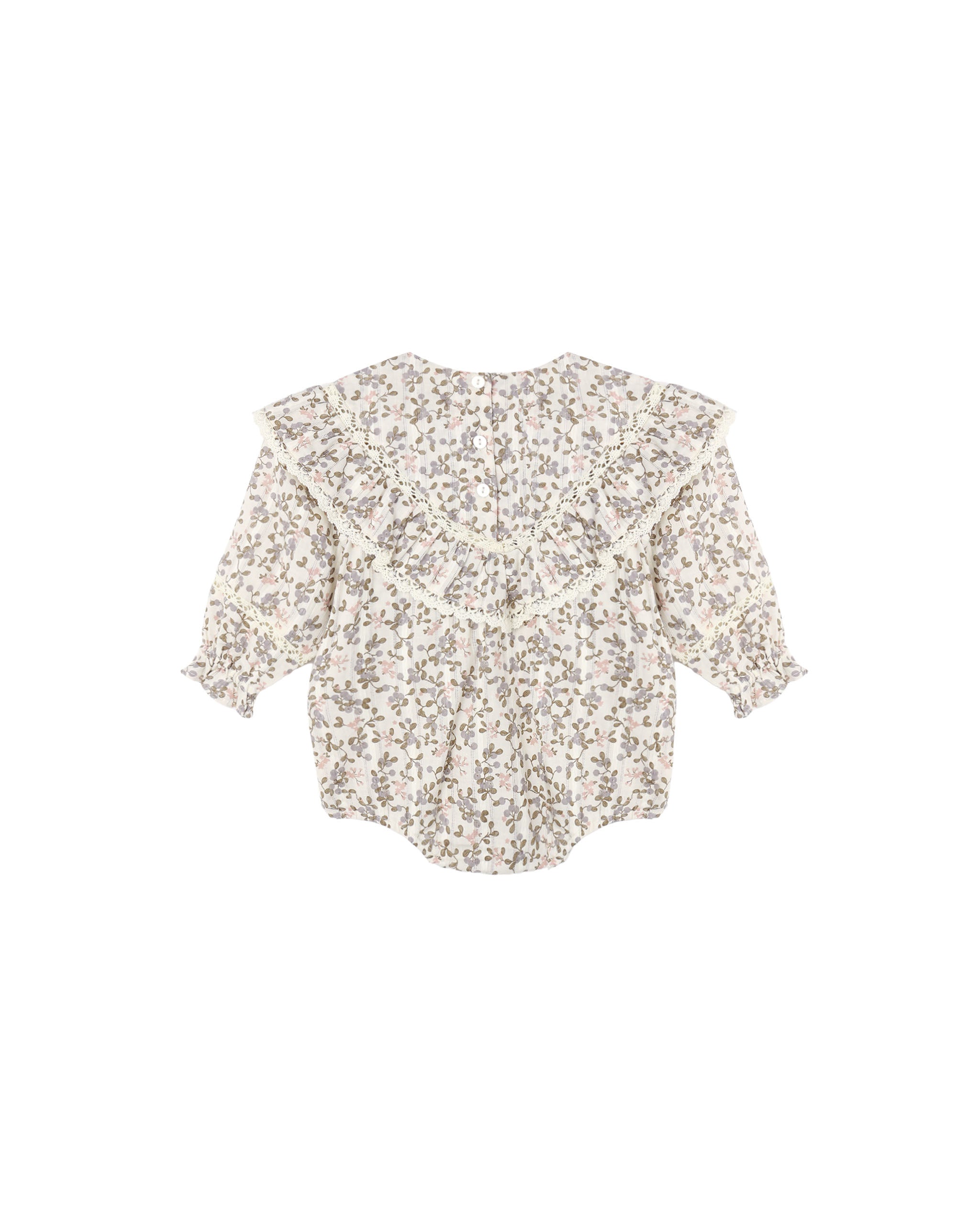 An ivory colored romper with a small floral pattern with a ruffle front shown on a white background.