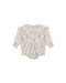 An ivory colored romper with a small floral pattern with a ruffle front shown on a white background.