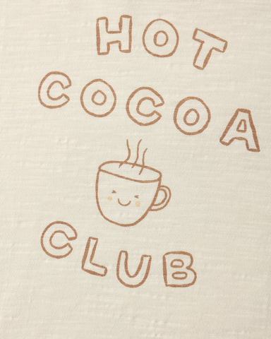 A close up of a natural colored long sleeve tee with a Hot Cocoa Club logo