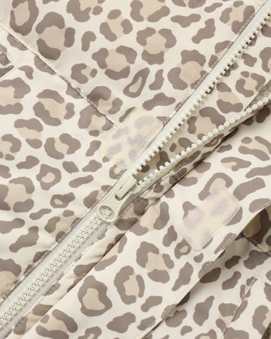 Close-up of a leopard print quilted jacket with a cream-colored zipper.