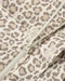 Close-up of a leopard print quilted jacket with a cream-colored zipper.