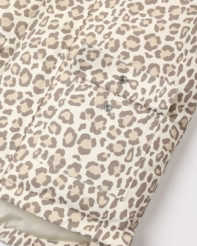 Close-up of a leopard print fabric with a matching pocket and silver snap buttons, shown against a plain light background.