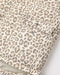 Close-up of a leopard print fabric with a matching pocket and silver snap buttons, shown against a plain light background.