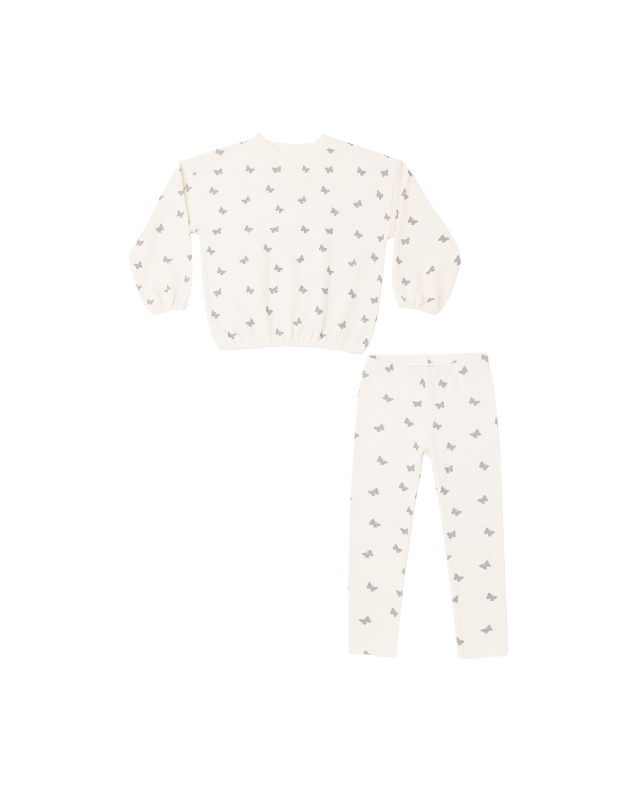 A two-piece children's sweatsuit featuring a long-sleeve top and matching pants in a warm off-white/cream color, both printed with a small repeating gray pattern of birds or butterflies.