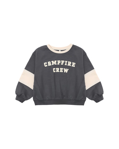 A dark gray sweatshirt with cream-colored color-blocked sleeves and collar, featuring the text 'CAMPFIRE CREW' printed in cream on the chest.