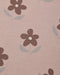 A close-up of a dusty pink fabric with a repeating pattern of dark brown flowers and light gray-green leaves.