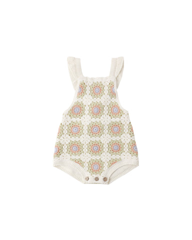Crochet baby romper with floral pattern on a white background
