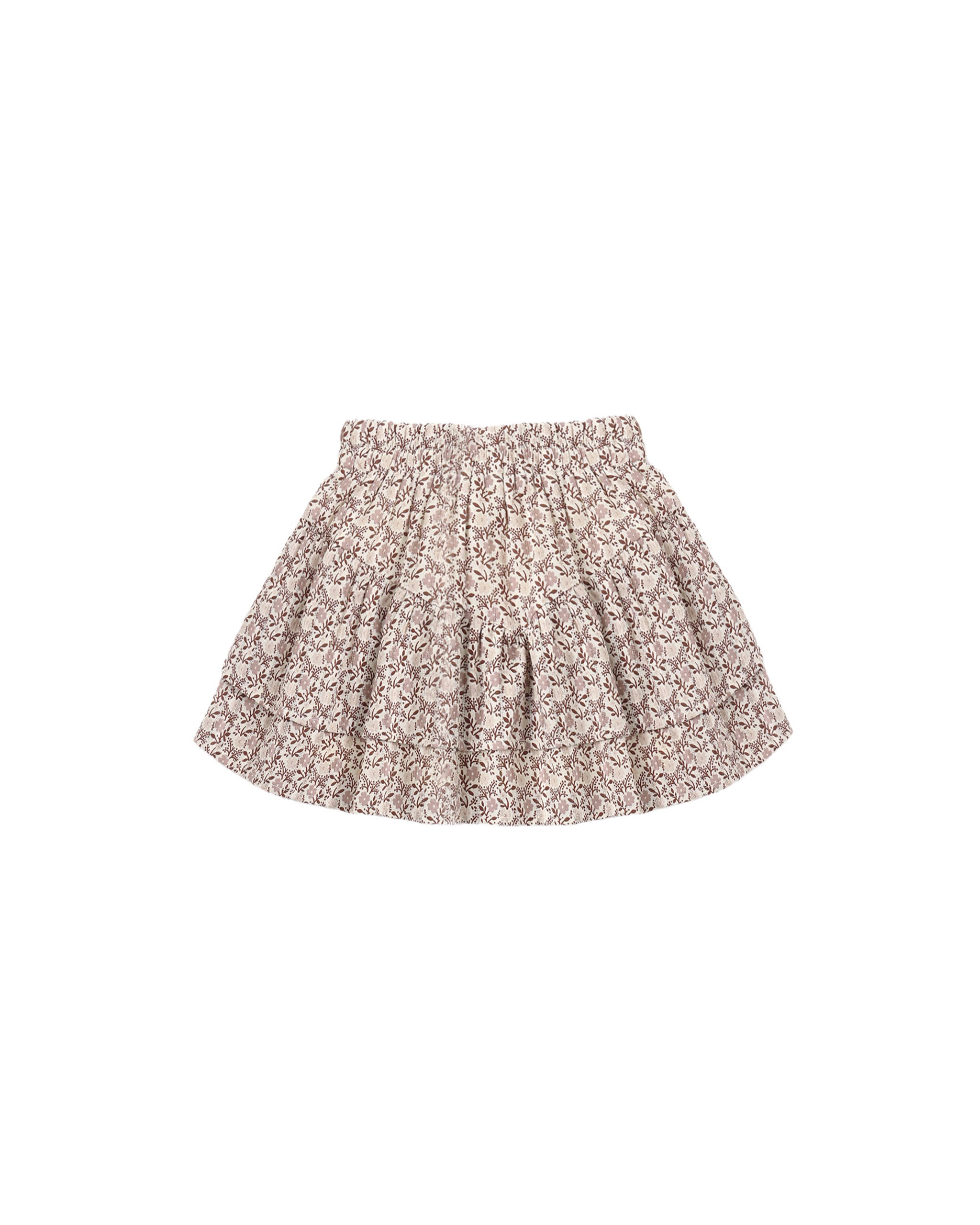 Tiered skirt in an all-over floral and leafy pattern in brown and dusty mauve on a warm off-white background.