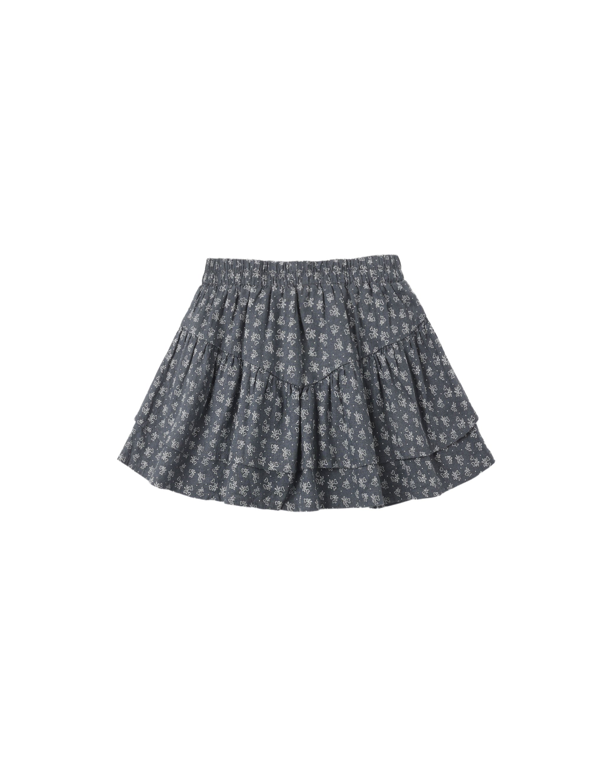 A dark gray tiered skirt with a small white floral pattern, shown flat against a solid white background.