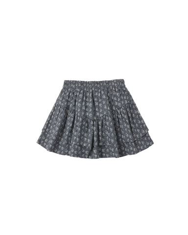 A dark gray tiered skirt with a small white floral pattern, shown flat against a solid white background.