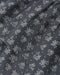 A close-up of dark gray fabric with a repeating white embroidered pattern of small flowers, hearts, and dots.