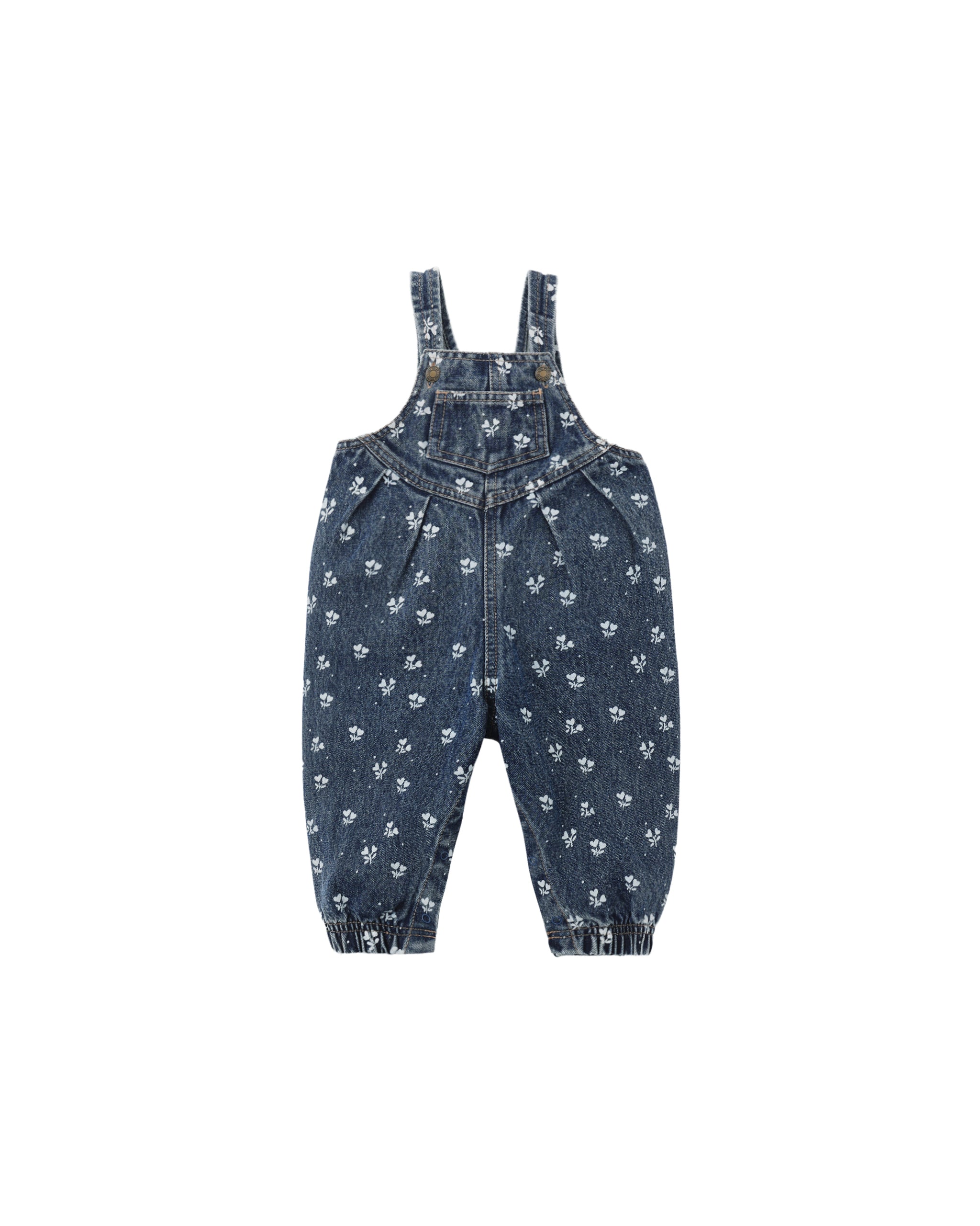 A pair of baby denim overalls in a dark blue wash, featuring an all-over small white floral pattern and elasticated ankle cuffs, shown flat on a white background.