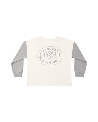 An ivory henley with a logo on the back that says "Made for Adventure".