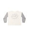 An ivory henley with a logo on the back that says "Made for Adventure".