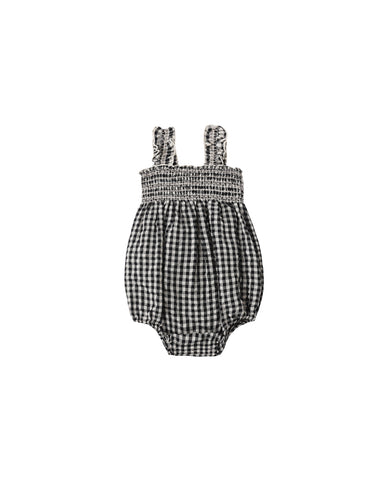 Black and white checkered baby romper on a white background