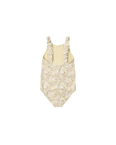 Beige swimsuit with floral details on a white background