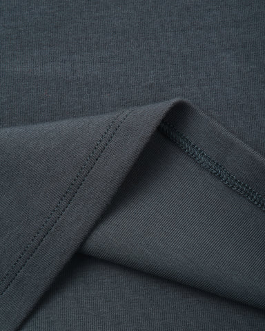 Close-up of a dark charcoal gray ribbed knit fabric with a folded corner showing the texture and stitching.