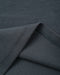 Close-up of a dark charcoal gray ribbed knit fabric with a folded corner showing the texture and stitching.