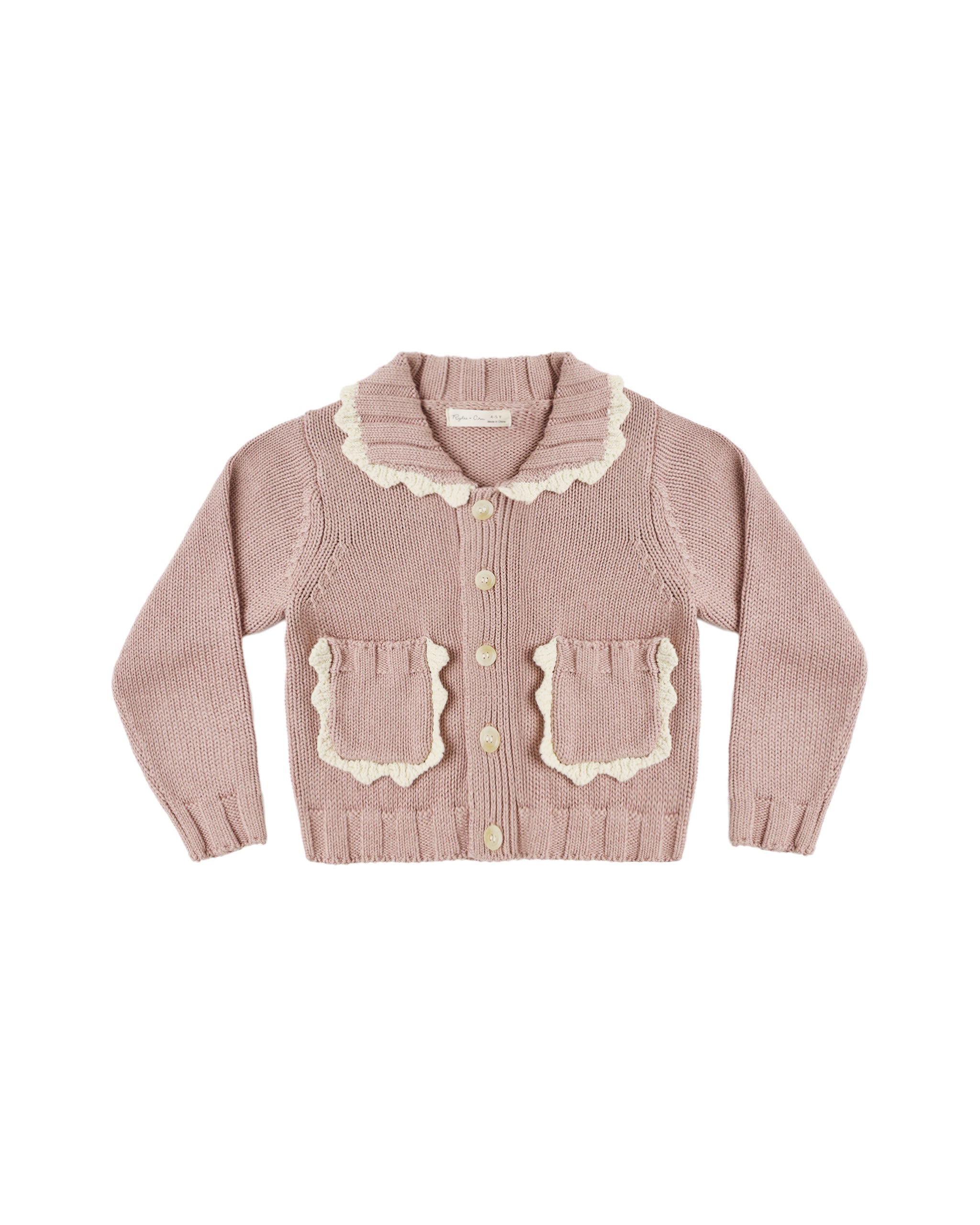 A dusty pink ribbed knit cardigan sweater for toddlers, featuring a cream-colored scalloped Peter Pan collar, matching scalloped pocket flaps, and cream buttons, shown flat on a white background.