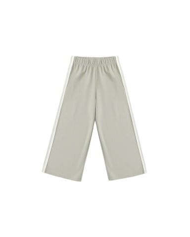 A pair of wide-leg track pants in a light sage green, featuring a white stripe down the side of each leg and an elastic waistband, shown against a plain white background.