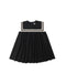 Black dress with white trim on a white background