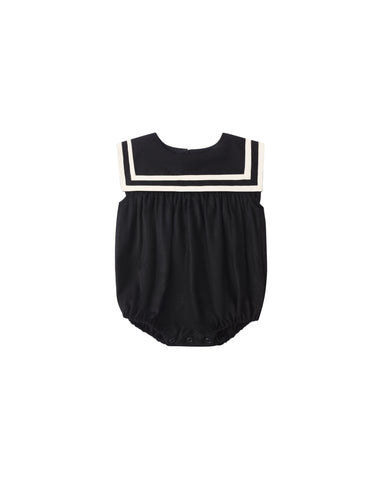 Black baby romper with white trim on a white background