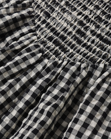 Close-up of black and white checkered fabric with a gathered waistband.