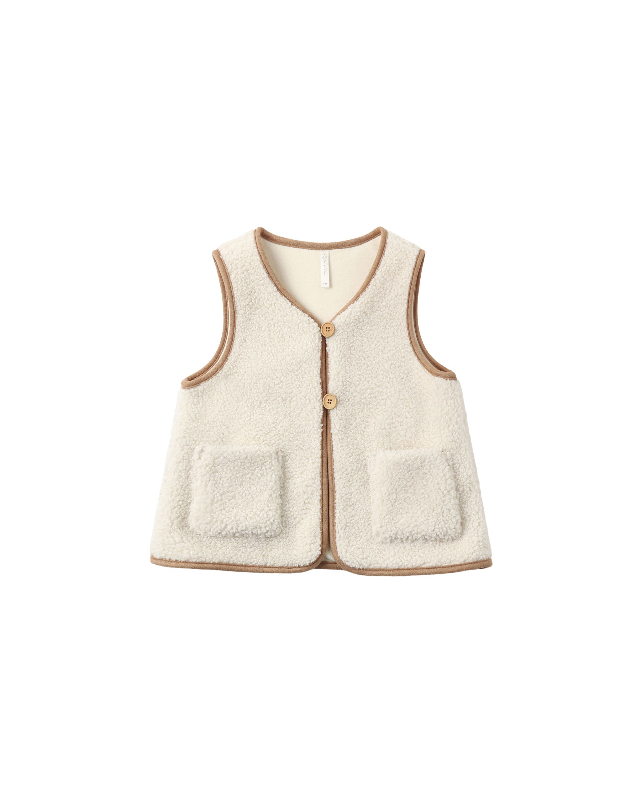 A cream-colored sherpa fleece vest with tan trim and two front patch pockets, shown flat on a white background.