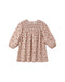 A blush colored dress with a floral pattern featuring a smocked front bodice, puff sleeves with encased elastic cuffs, and delicate crochet lace inlay