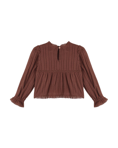 A brown long-sleeve knit top with a high round neckline, a small front keyhole detail, and a gathered peplum waist, shown against a plain white background.