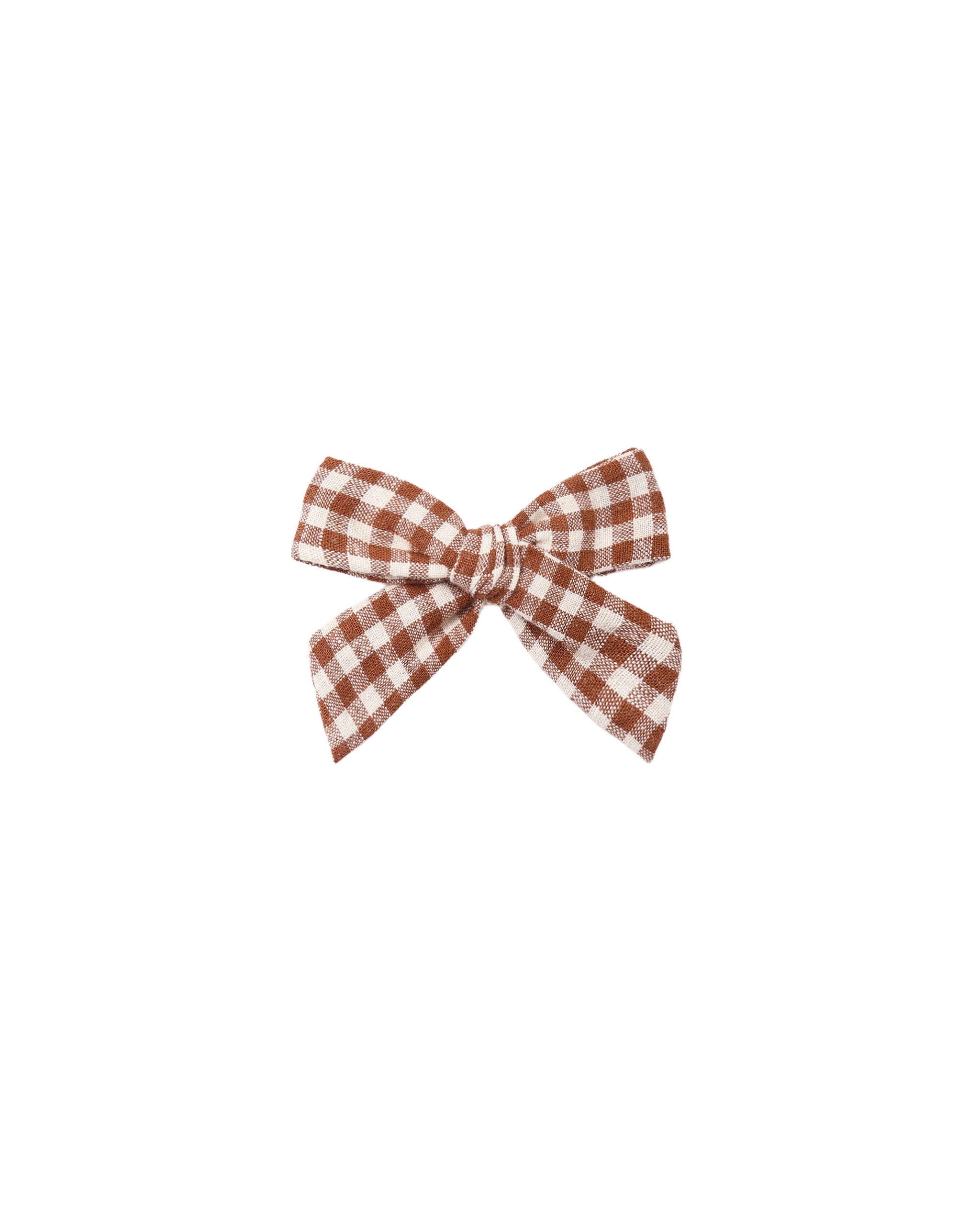 A sweet bow in a brown checked fabric attached to an alligator clip